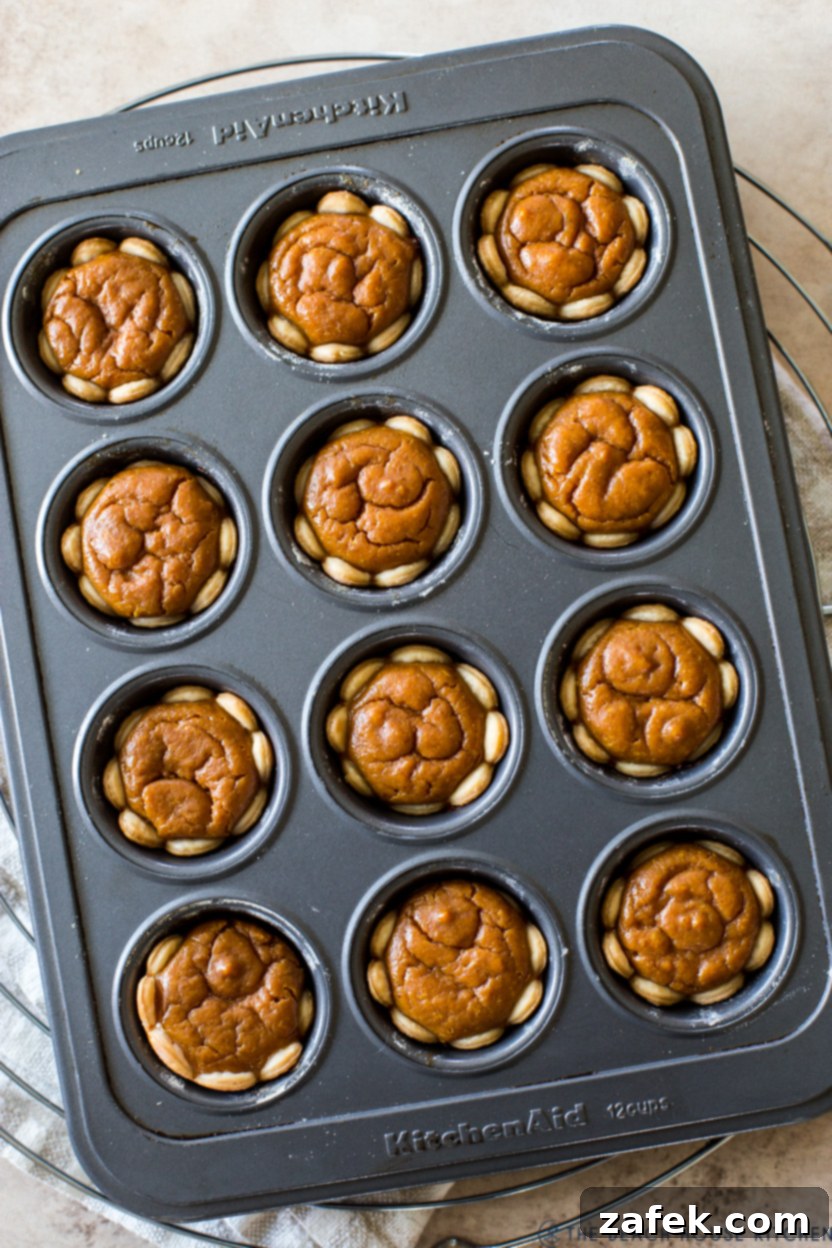 Up close overhead photo of mini pumpkin pies in a muffin tin