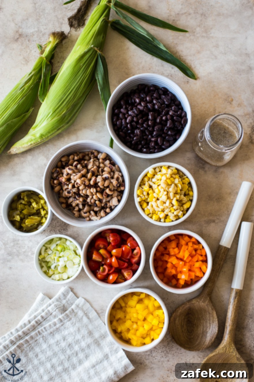Lone Star Fiesta Salad 5 An overhead shot showcasing all the fresh ingredients for Texas Caviar, neatly arranged in separate white bowls, highlighting the vibrant colors and readiness for assembly.