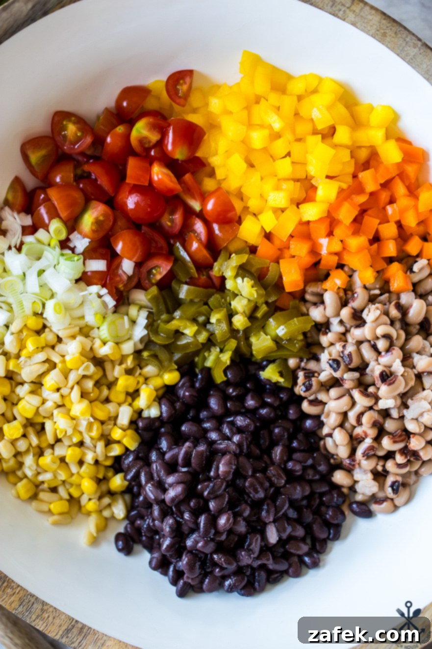 Lone Star Fiesta Salad 6 A freshly mixed bowl of Texas Caviar, vibrant and ready to be covered and chilled, promising a delicious and healthy treat after the flavors meld.