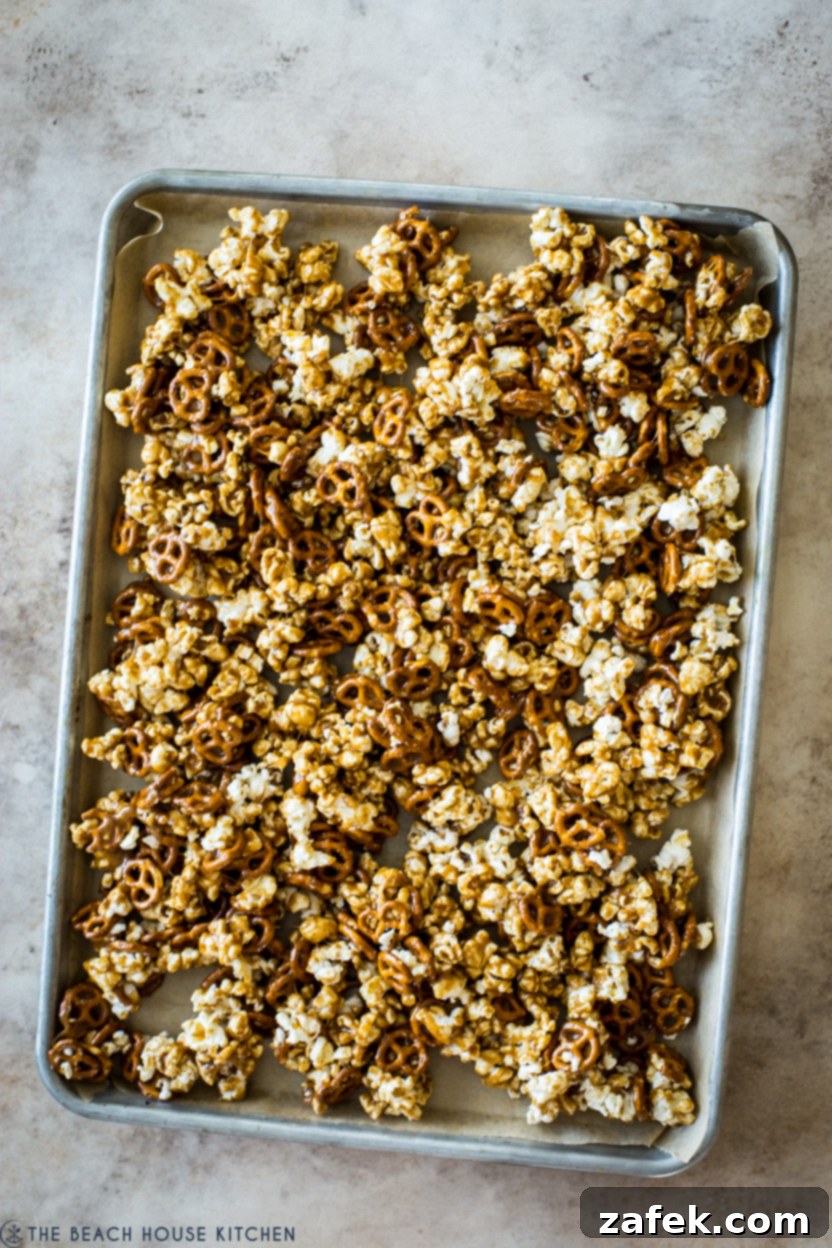 Gourmet Gingerbread Caramel Pretzel Popcorn 6 Overhead photo of pre-baked caramel popcorn on a baking sheet