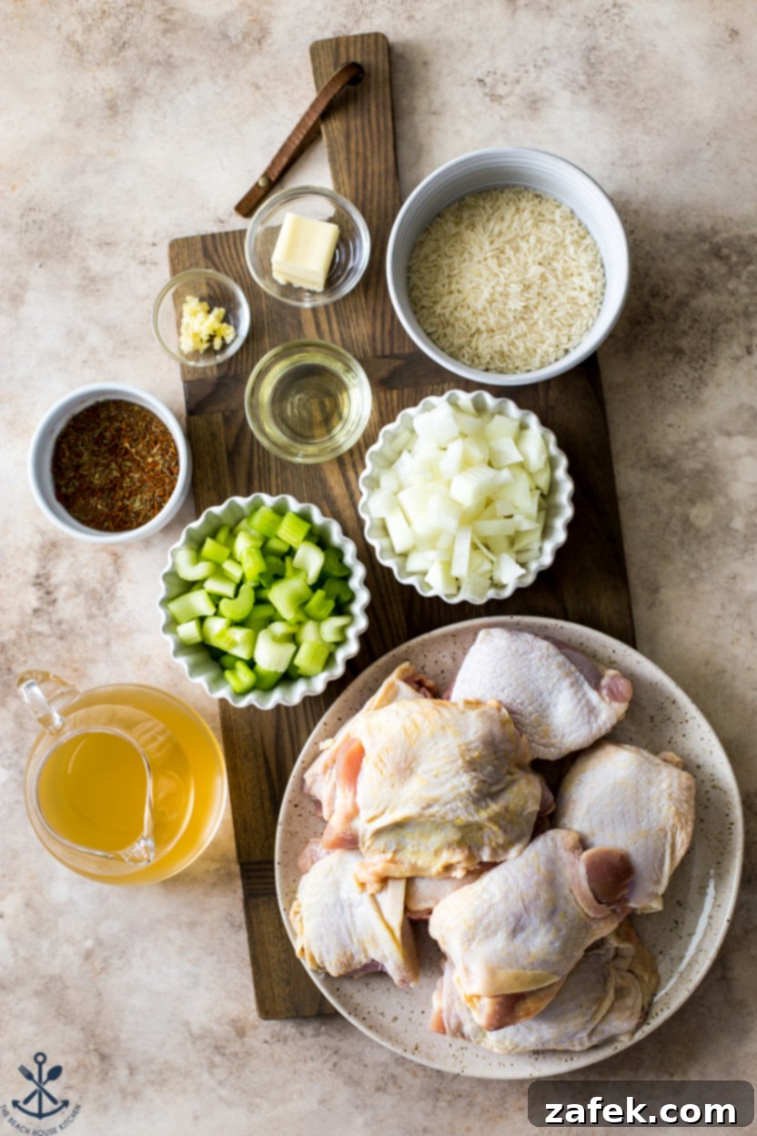 A Taste of Home: Mum's Chicken and Rice 5 Overhead photo of various fresh ingredients for Mum's Chicken and Rice arranged neatly on a rustic wooden board, including bone-in chicken thighs, basmati rice, yellow onions, celery stalks, garlic cloves, a lemon, and a selection of spices.