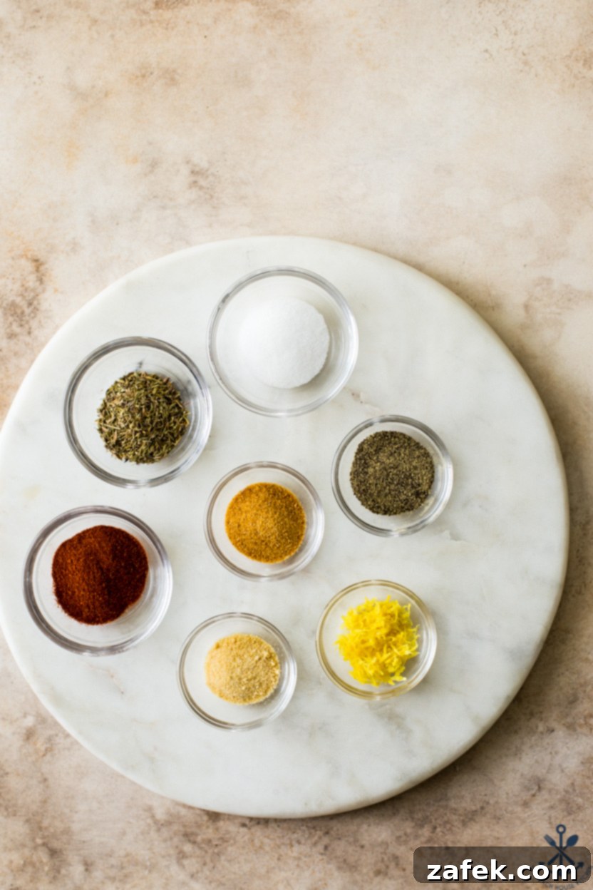A Taste of Home: Mum's Chicken and Rice 6 Overhead photo of a sleek round marble board displaying an assortment of small glass bowls, each holding a different spice for the chicken and rice dish, including paprika, thyme, and lemon zest.