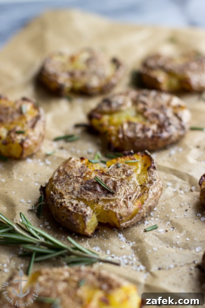 Roasted Smashed Potatoes on a plate with fresh herbs