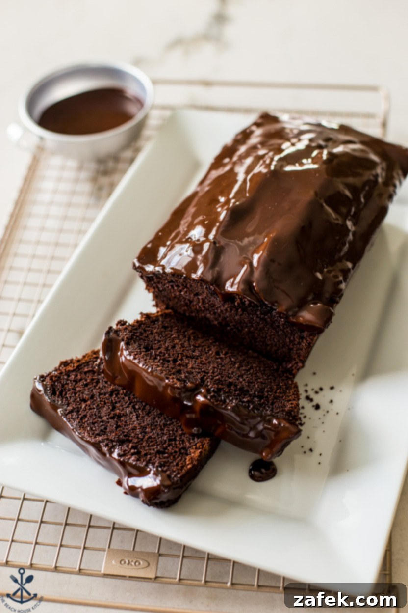 Decadent Chocolate Loaf 2 Up close photo of a sliced chocolate loaf cake