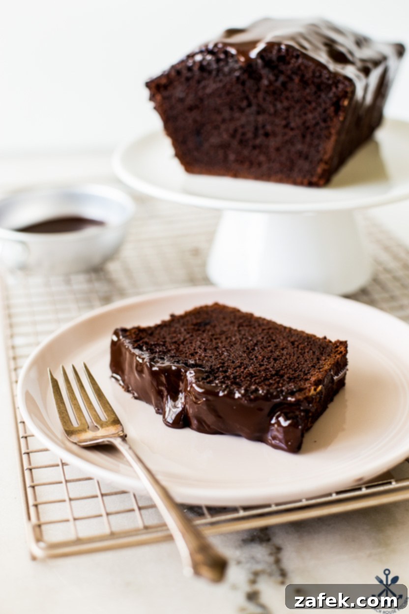 Decadent Chocolate Loaf 3 Up close photo of a slice of chocolate loaf cake