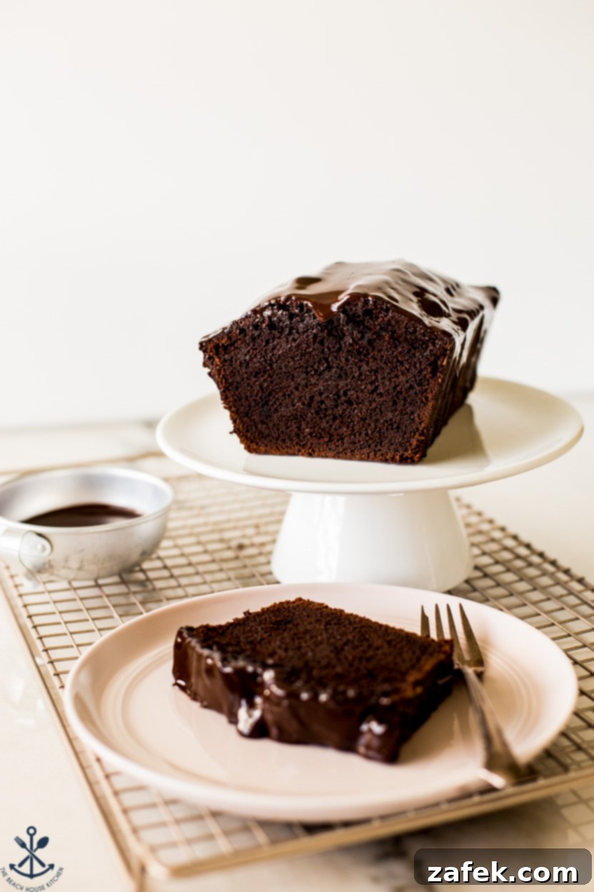 Decadent Chocolate Loaf 7 Zoomed in photo of a chocolate loaf cake on a cake stand