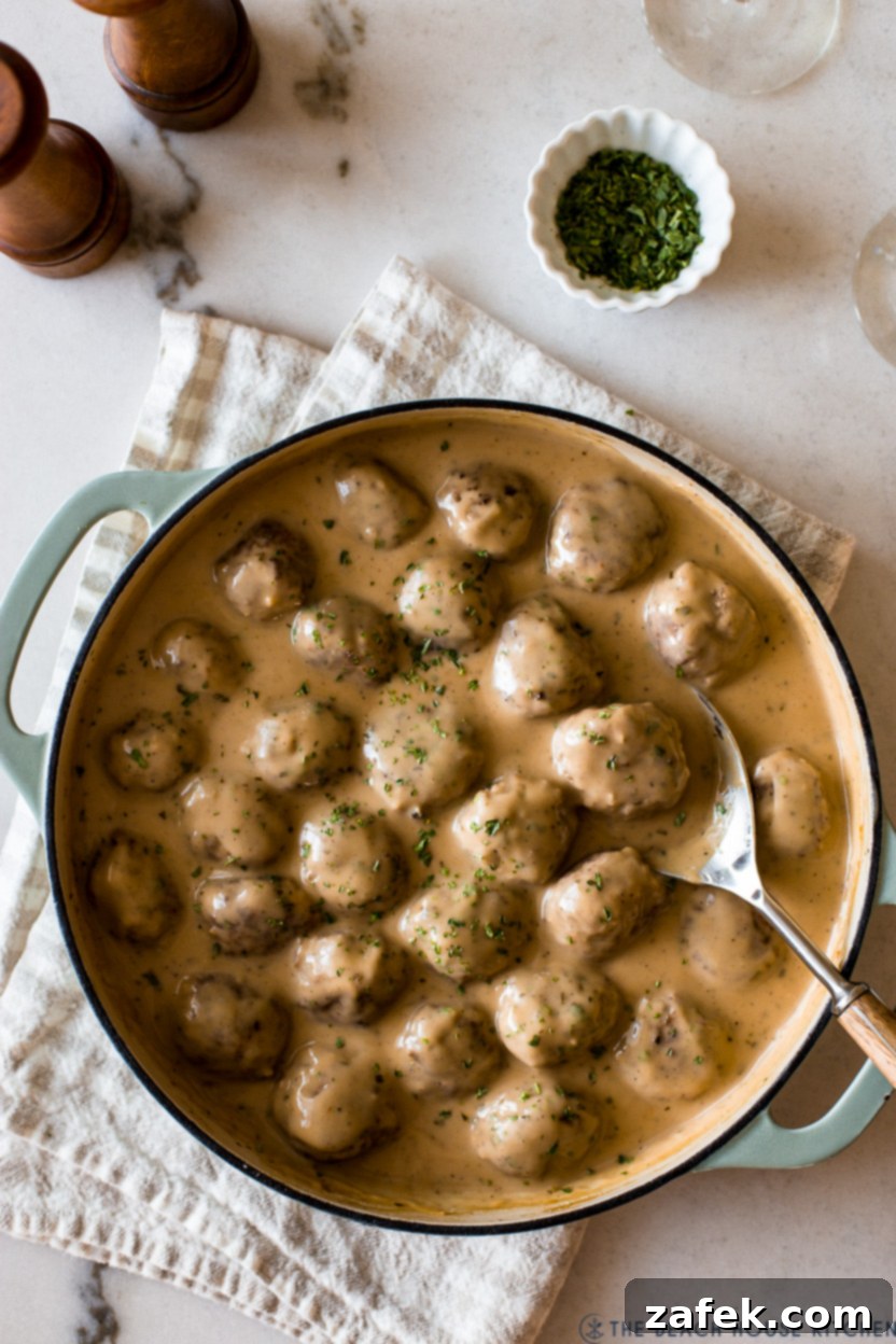 Overhead photo of a skillet of finished Swedish Meatballs, garnished and ready to serve