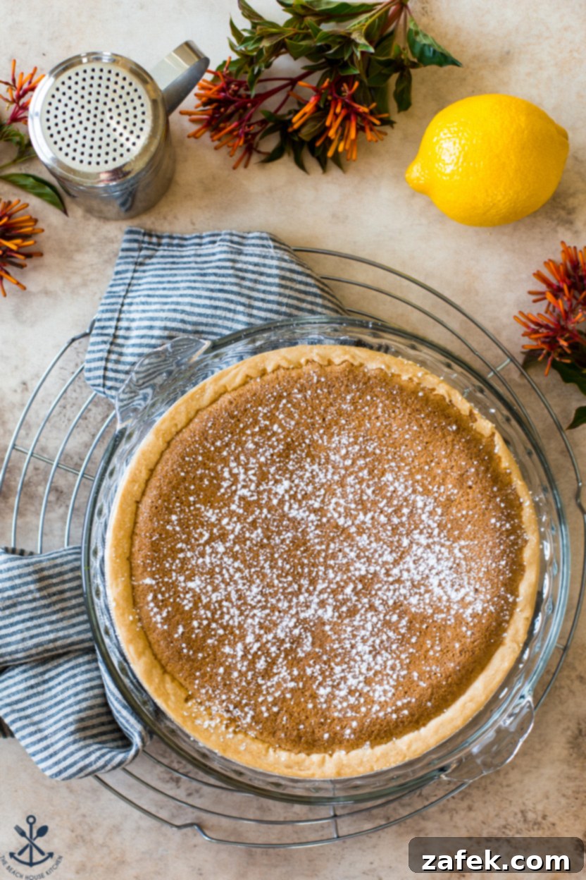 Tangy Lemon Chess Pie 2 Overhead photo of a beautifully baked Lemon Chess Pie on a round wire cooling rack, ready to be served.
