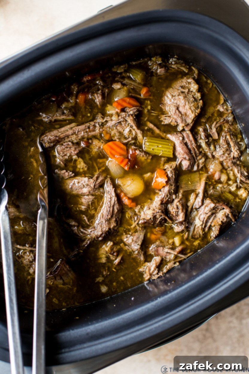 Up close overhead photo of Slow Cooker Italian Beef, showing the shredded meat and saucy texture