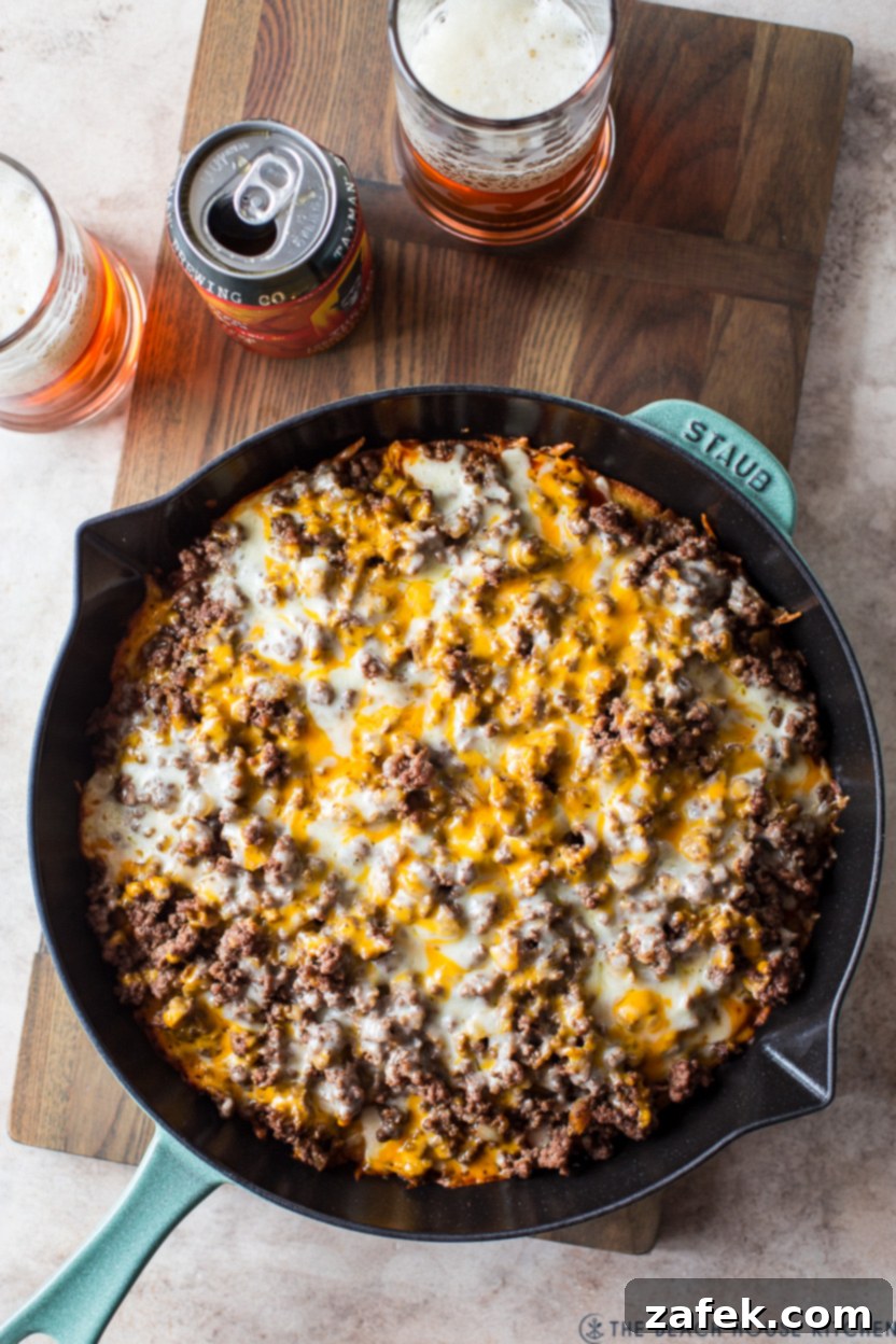 Southwest Tamale Bake 3 Overhead photo of a skillet tamale pie, beautifully baked with melted cheese and a golden cornbread edge