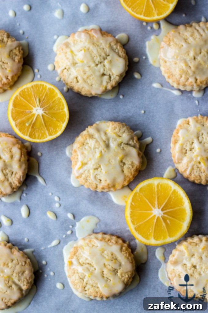 Close-up of freshly baked Meyer Lemon Cream Scones on a cooling rack, showing their tender texture