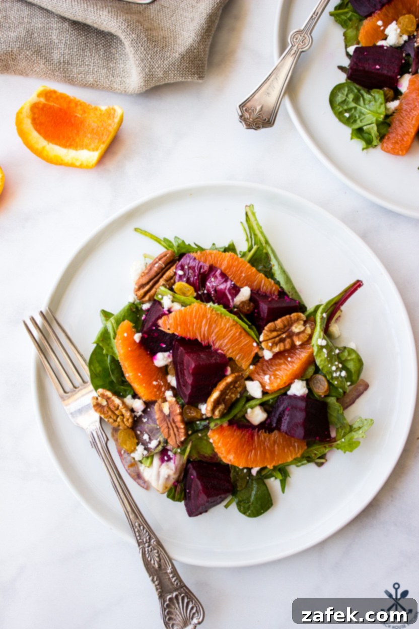 Vibrant Beet and Orange Salad 2 Overhead photo of a beet and orange salad on a white plate