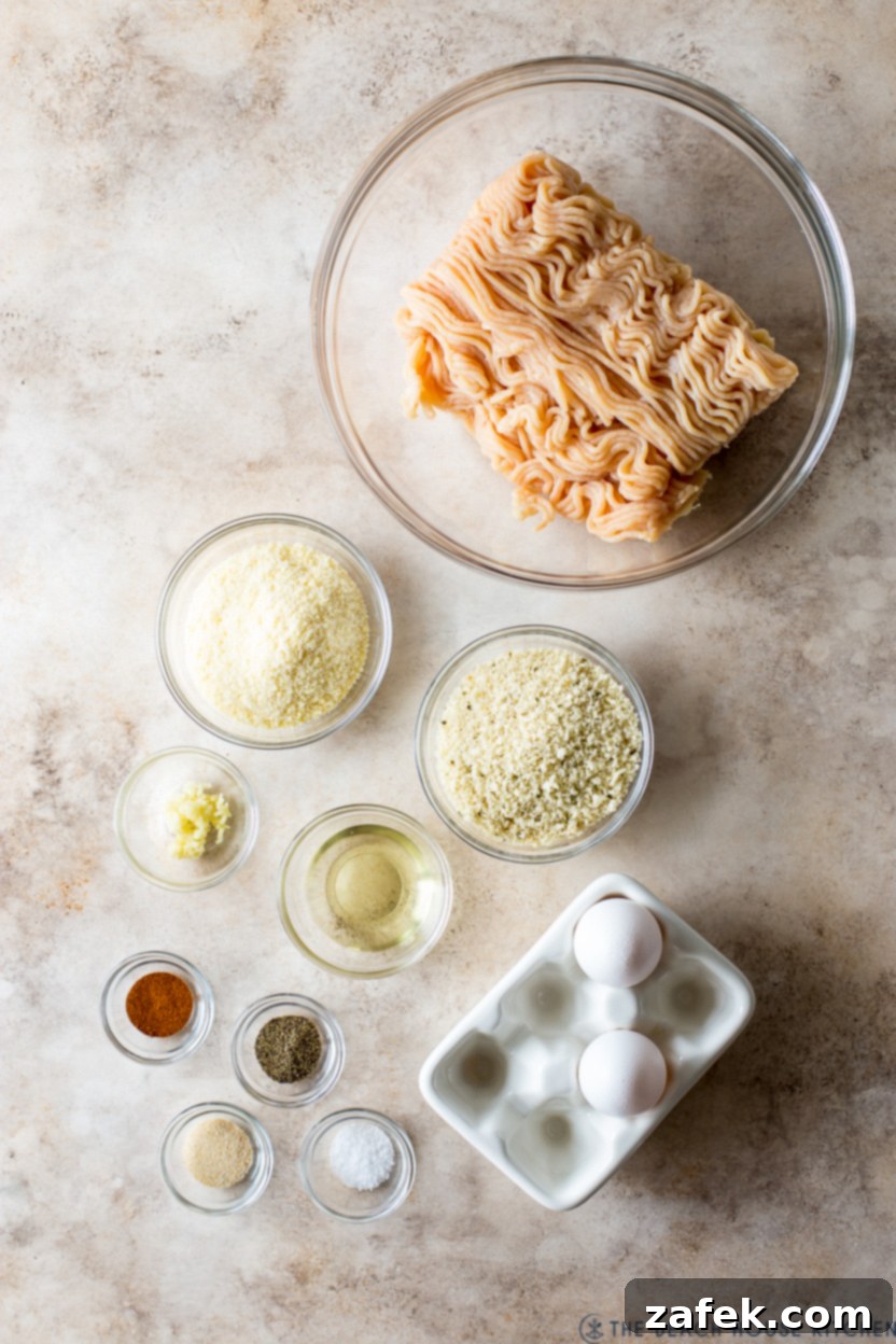 A serving of chicken piccata meatballs with a side of pasta, drizzled generously with the lemon-caper sauce and garnished.