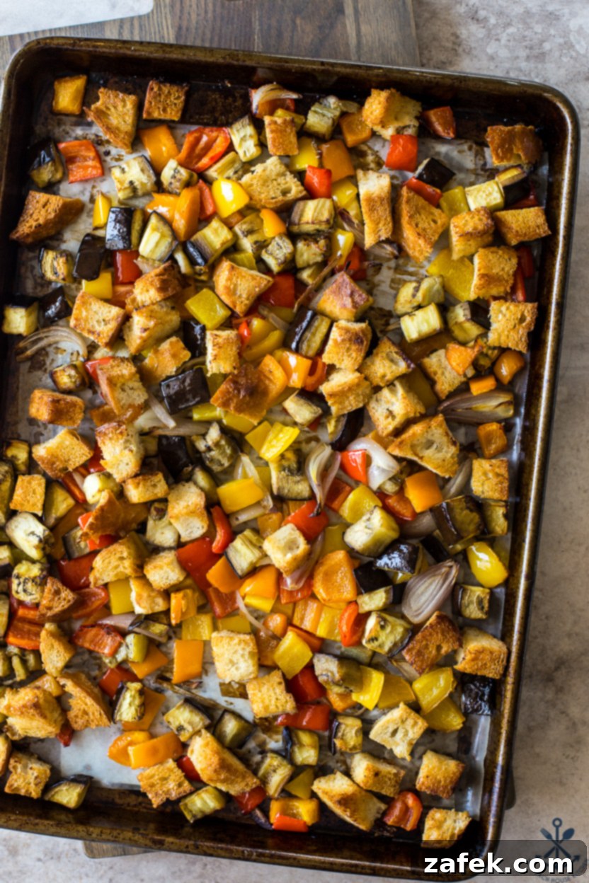 Overhead photo of a vibrant Sheet Pan Roasted Vegetable Panzanella, showcasing crispy bread, roasted eggplant, and colorful bell peppers