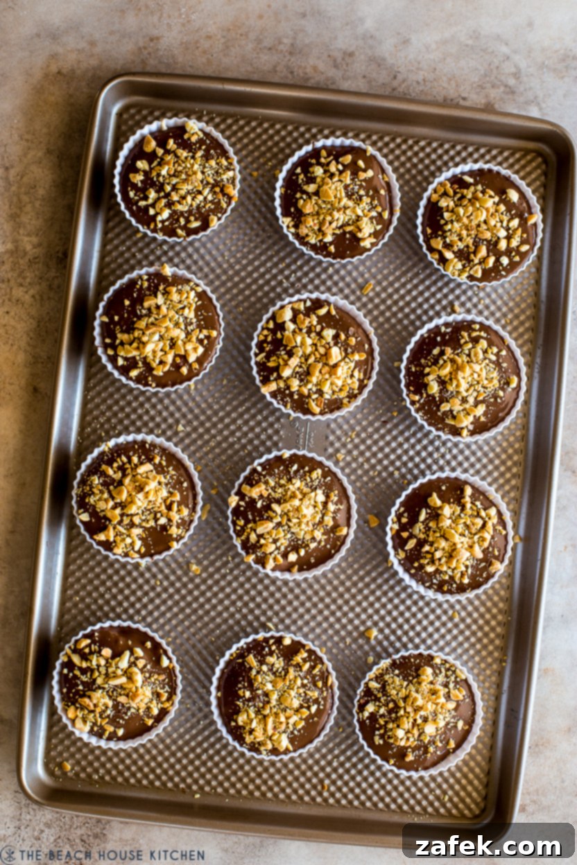 Caramel Peanut Chocolate Dream Cups 10 An overhead photo of a baking sheet filled with beautifully made homemade Snickers cups, ready to be picked up and enjoyed.