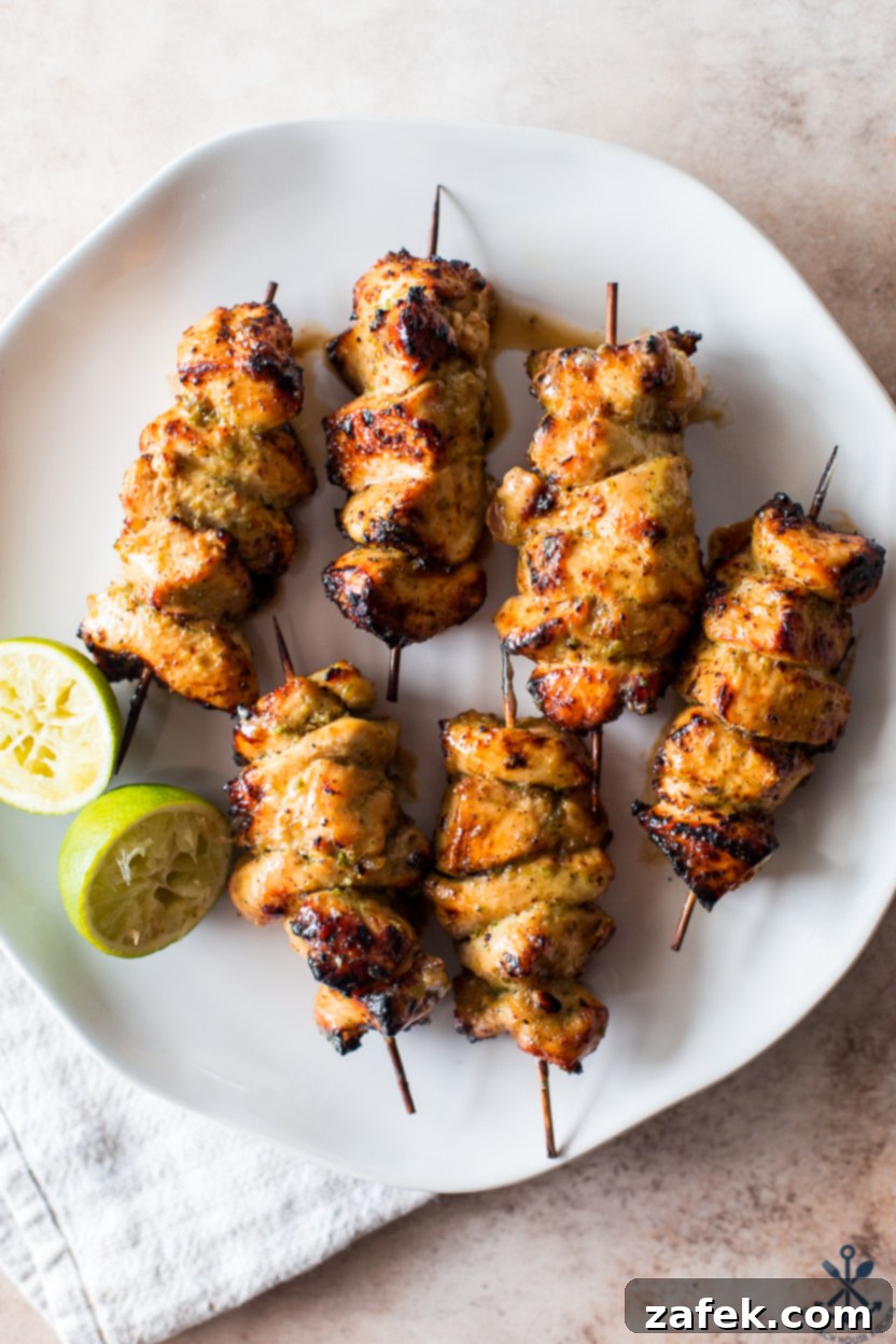 Zesty Sweet Heat Air Fryer Chicken Skewers 3 Up close overhead photo of perfectly cooked Air Fryer Honey Jalapeño Lime Chicken Skewers garnished with fresh cilantro