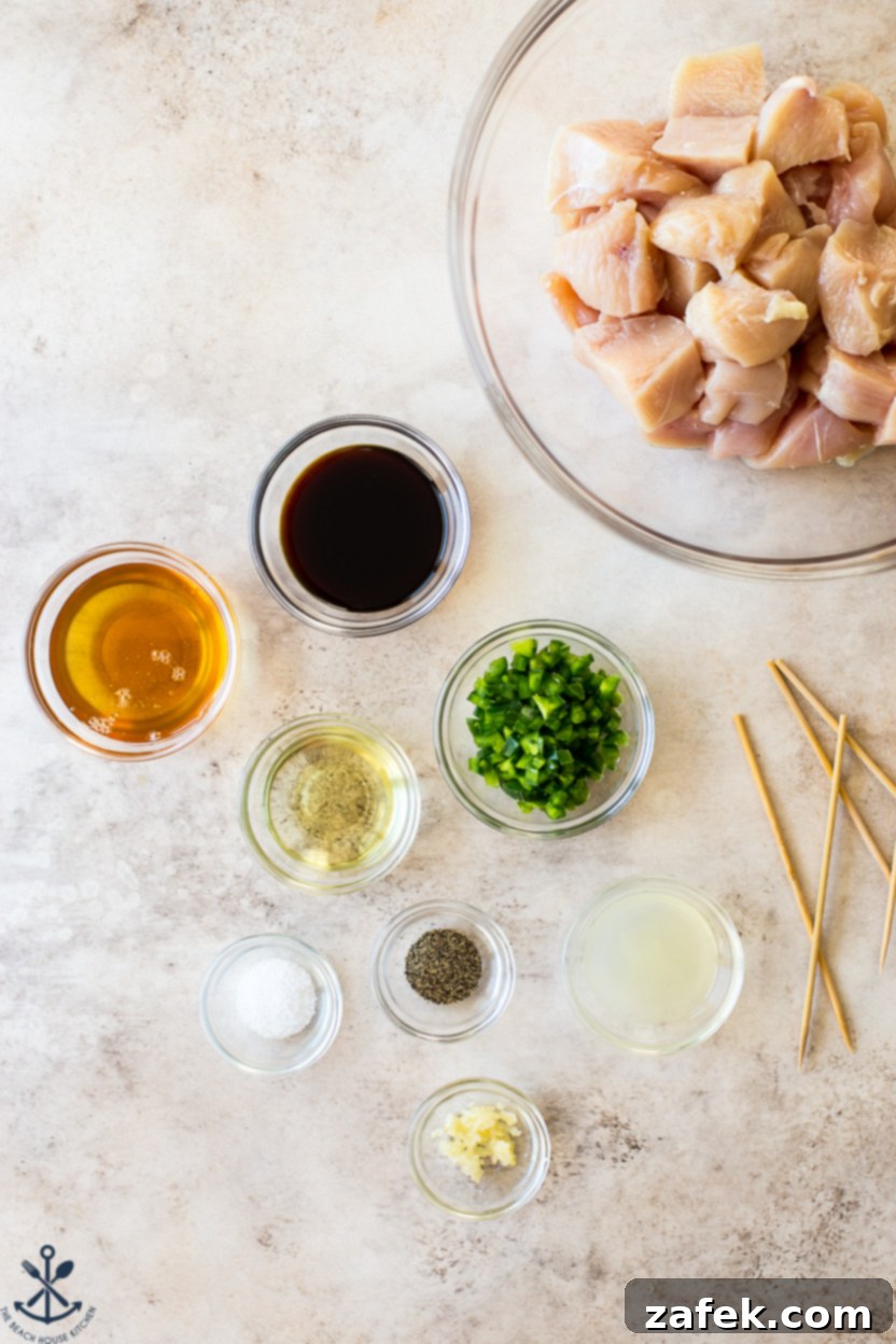 Zesty Sweet Heat Air Fryer Chicken Skewers 4 Overhead photo of fresh ingredients for honey jalapeno lime chicken marinade including lime, honey, soy sauce, and diced jalapeno