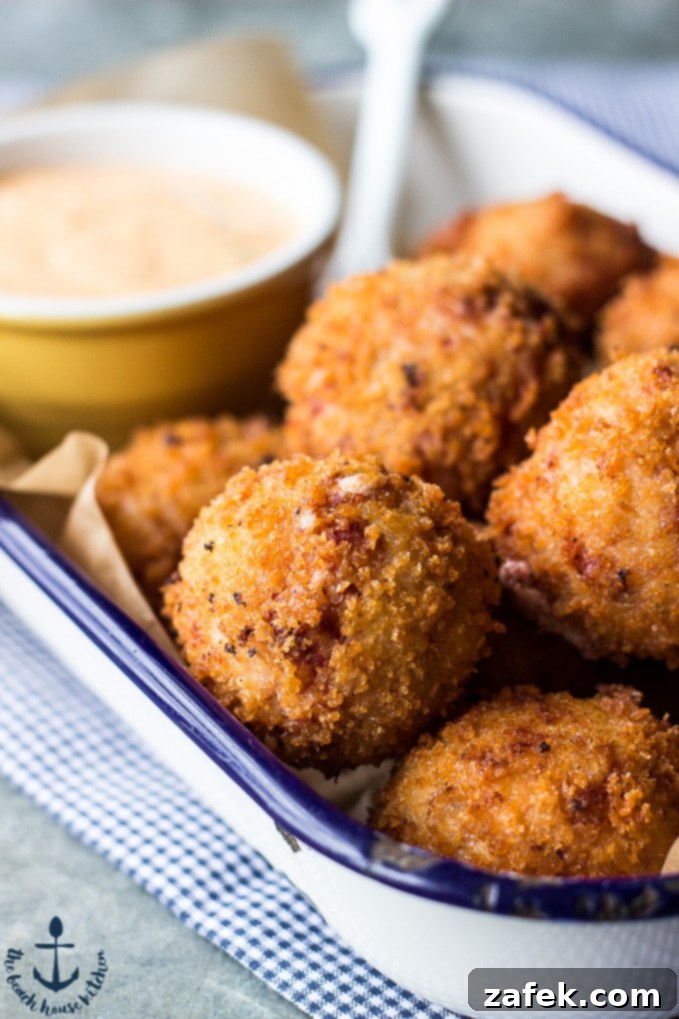 Reuben Poppers Your New Craving 5 A plate of golden brown Reuben Poppers with a small bowl of Russian dressing.