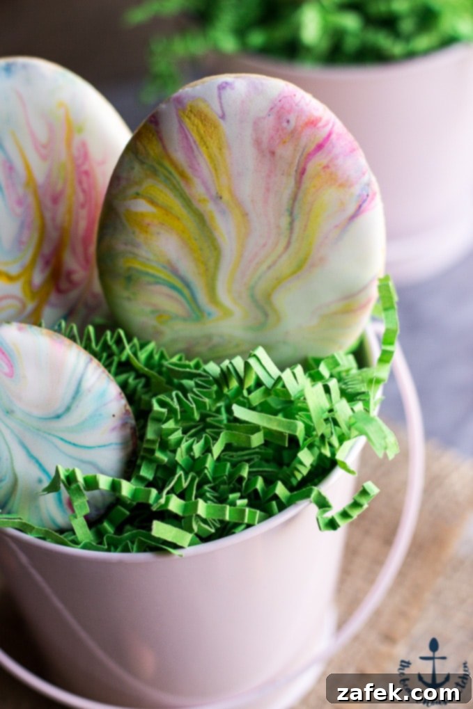 A collection of vibrant Easter Egg Sugar Cookies, featuring various marbled royal icing patterns