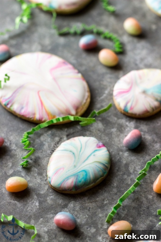 Two Easter Egg Sugar Cookies, one large and one small, showcasing different marbled designs against a soft background