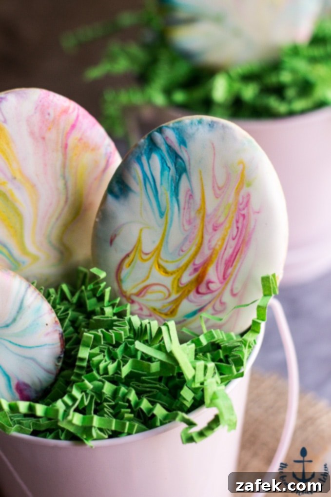 Assorted Easter Egg Sugar Cookies in a basket, decorated with various marbled royal icing colors, ready for an Easter celebration