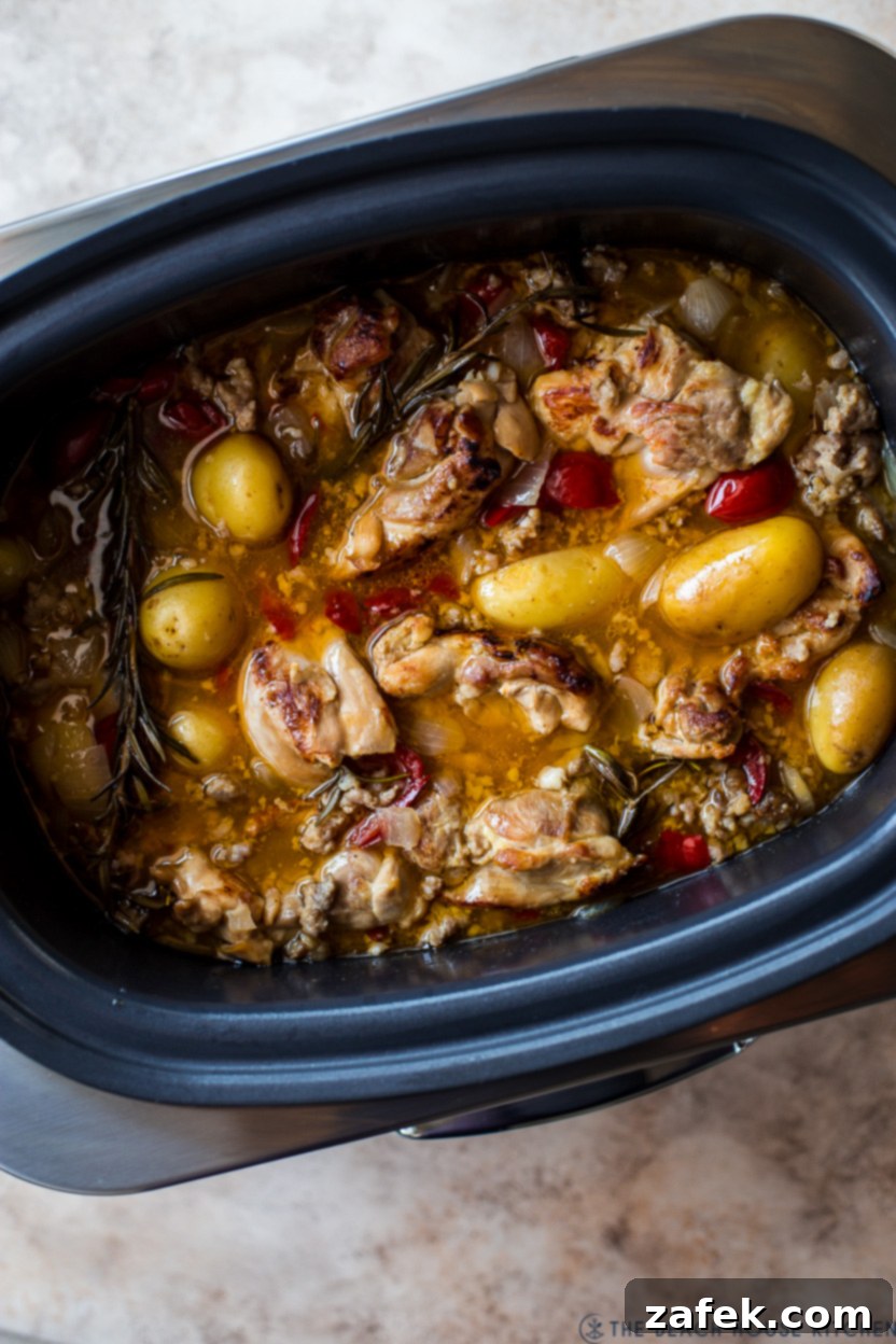 Chicken Scarpariello simmering in a slow cooker, showing the rich sauce and ingredients