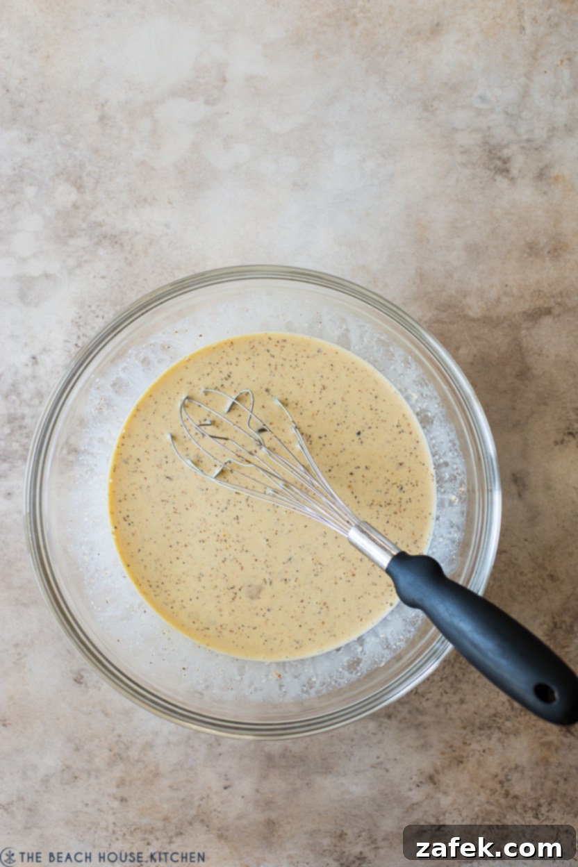Loaded Mexican Quiche Boats 5 Overhead photo of a bowl filled with an egg custard mixture, perfectly whisked