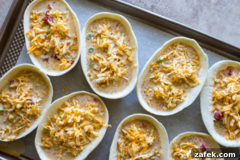 Loaded Mexican Quiche Boats 7 Overhead photo of pre-baked taco boat quiches, filled and ready for the oven