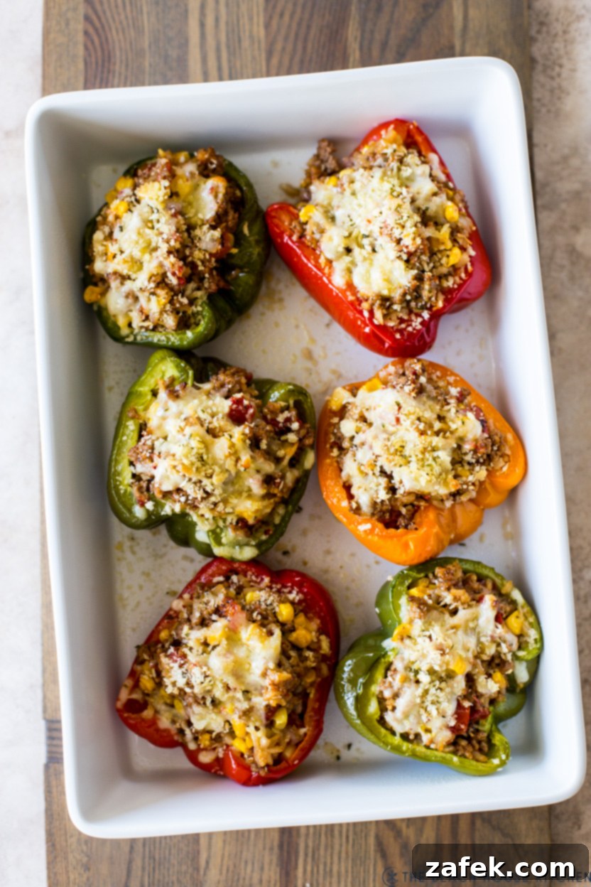 Savory Stuffed Peppers 3 Overhead photo of beautifully baked stuffed peppers in a white ceramic baking dish, ready to be served