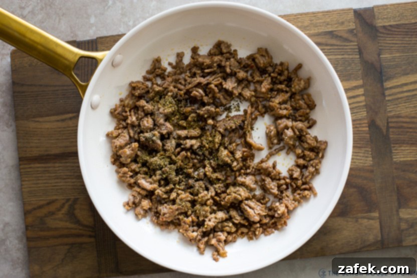 Overhead photo of a skillet of crumbled cooked Italian sausage