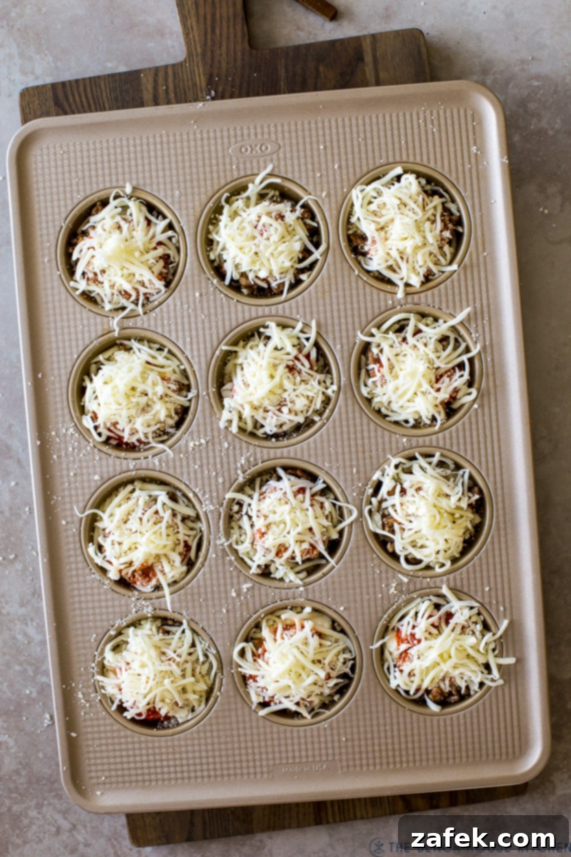 Overhead photo of pre-baked lasagna cups in a muffin tin