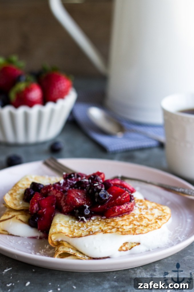 Coconut Crepes with Whipped Greek Yogurt and Berry Compote - A vibrant spring breakfast