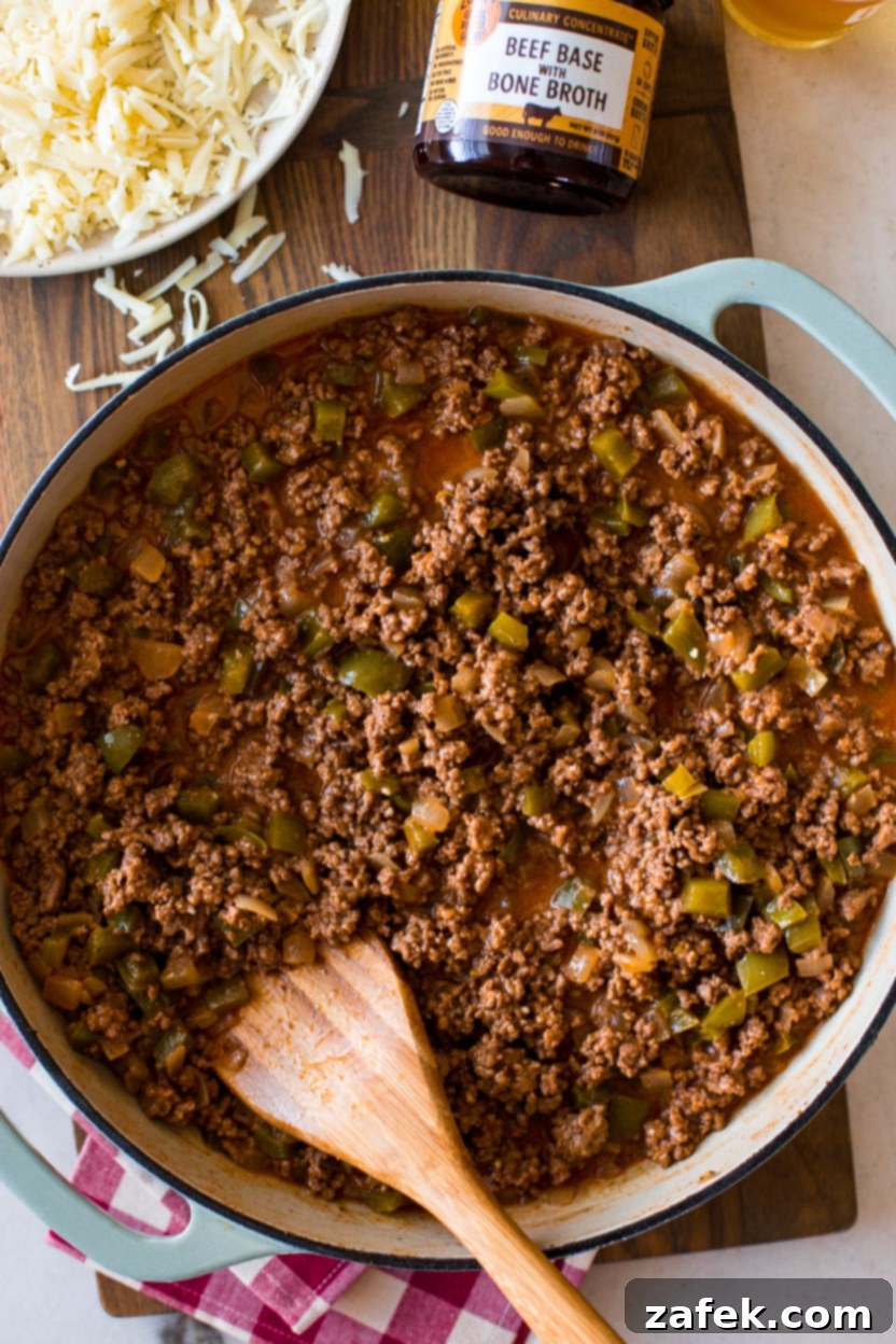 Overhead photo of a skillet filled with rich, cheesy Philly Cheesesteak Sloppy Joes mixture, ready to be served