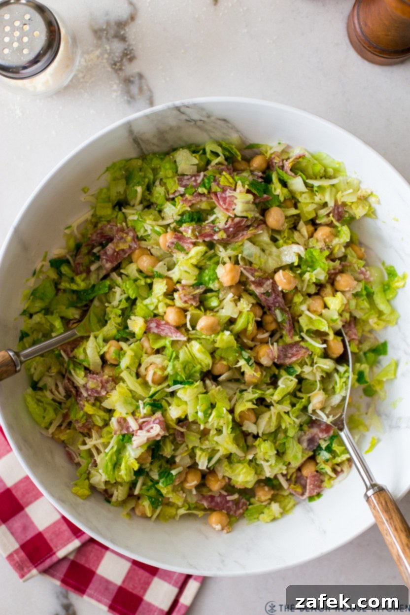 Close-up overhead view of a well-mixed La Scala Chopped Salad in a clean white bowl