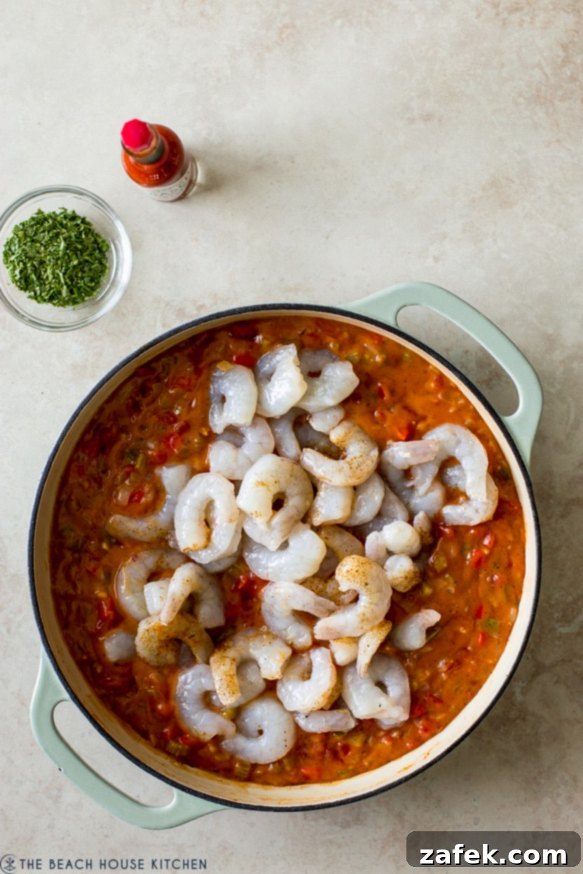 Bayou Shrimp with Creole Kick 7 Overhead photo of a veggie mixture topped with raw shrimp