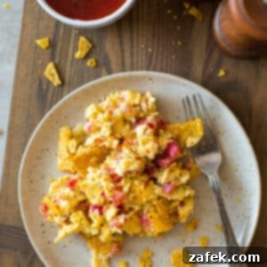 A close-up image of a perfectly cooked bowl of Tex-Mex Migas, showing its rich texture and vibrant ingredients.