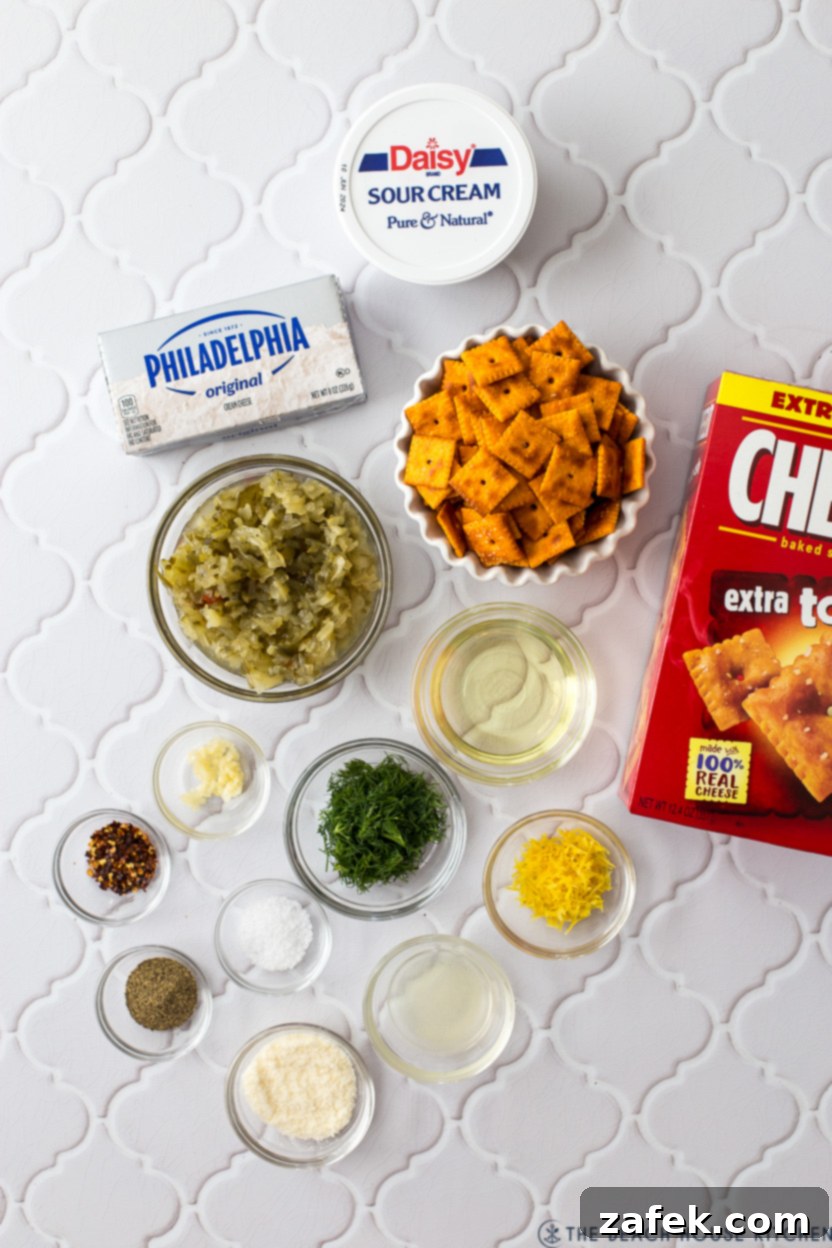 Ingredients laid out for Dill Pickle Dip preparation, including cream cheese, sour cream, relish, and Cheez-Its.