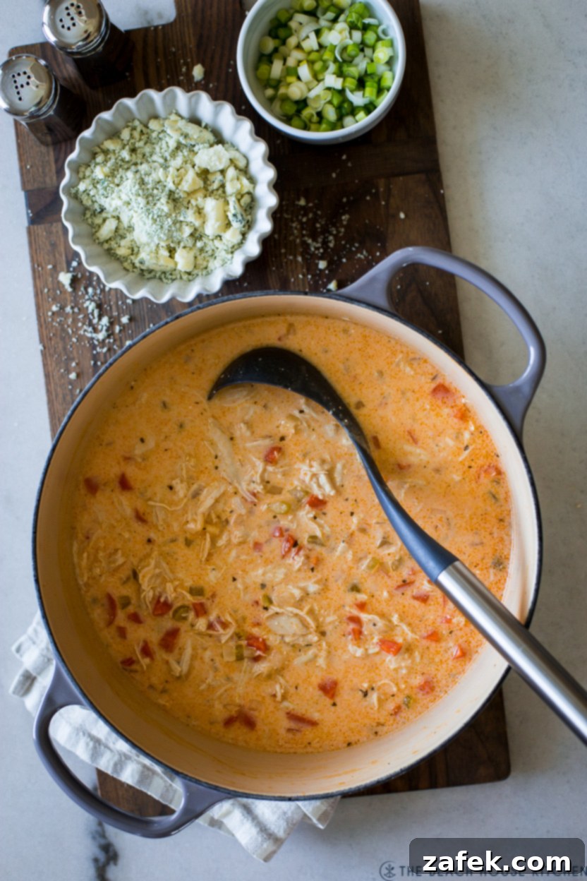 Hot Wing Soup 12 An overhead shot of a large, rustic pot filled with rich, creamy Buffalo Chicken Soup, ready to be served.