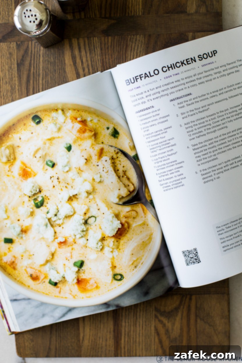Hot Wing Soup 5 An overhead shot of a cookbook opened to a page featuring a buffalo chicken soup recipe, with a focus on the delicious dish.