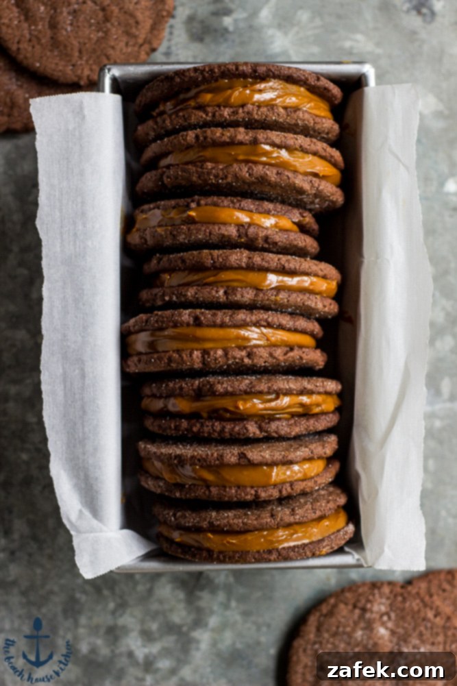 Overhead view of several Mexican Chocolate Sandwich Cookies with creamy Dulce de Leche filling, arranged appealingly in a loaf pan