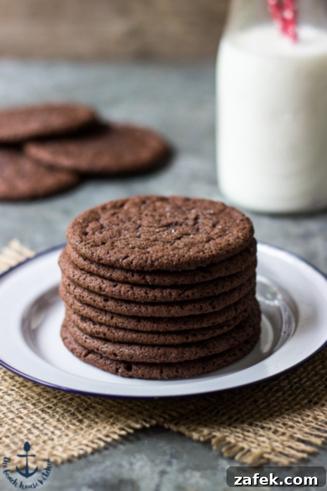 Close-up shot of Mexican Chocolate Cookies on a rustic plate, highlighting their textured surface before filling