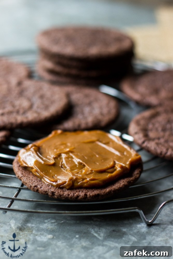 An open Mexican Chocolate Sandwich Cookie revealing its thick, creamy Dulce de Leche filling, ready to be savored