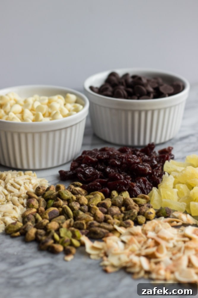 Close-up of a variety of Christmas Mendiants featuring dark and white chocolate with different toppings.
