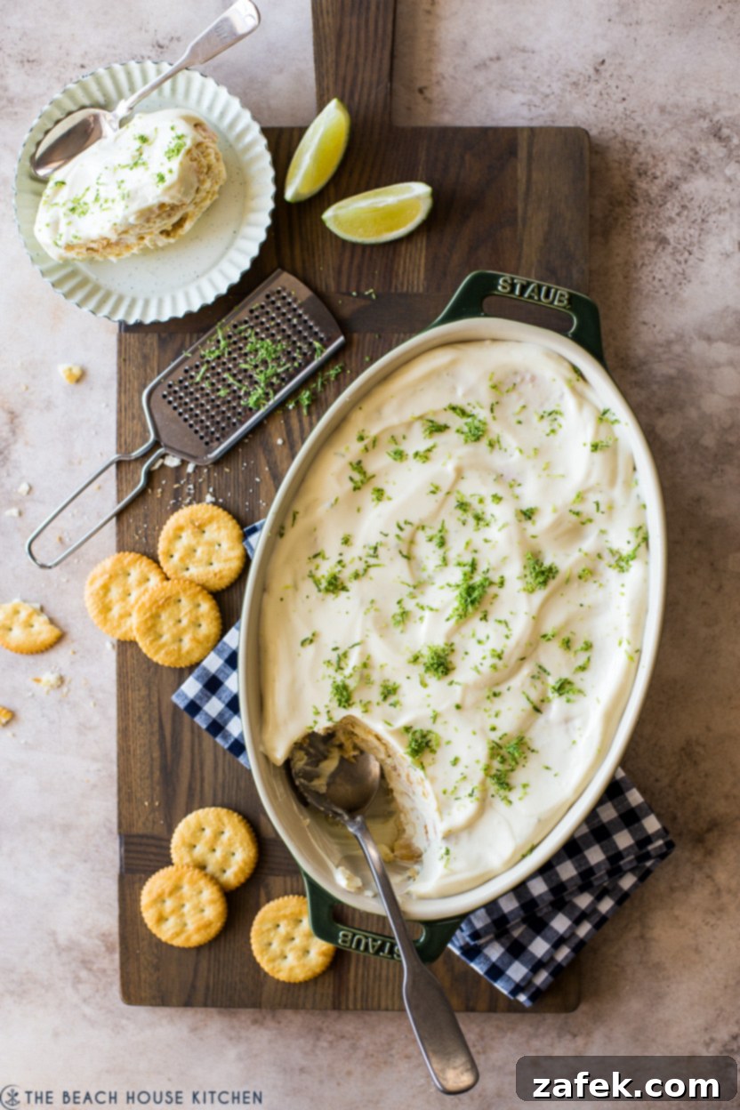 Overhead photo of a key lime cracker pie in an oval dish, garnished with fresh lime zest