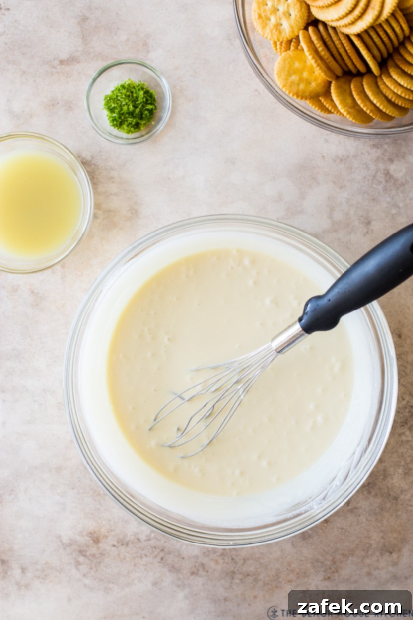 Overhead photo of a bowl of key lime filling with a whisk, showing its creamy texture