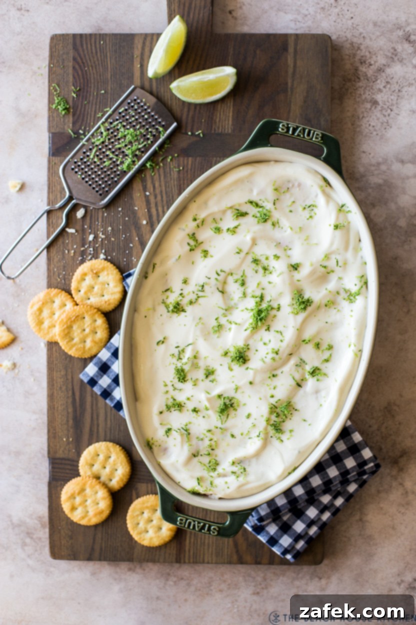 Overhead photo of a key lime cracker pie in an oval dish, sliced and ready to serve