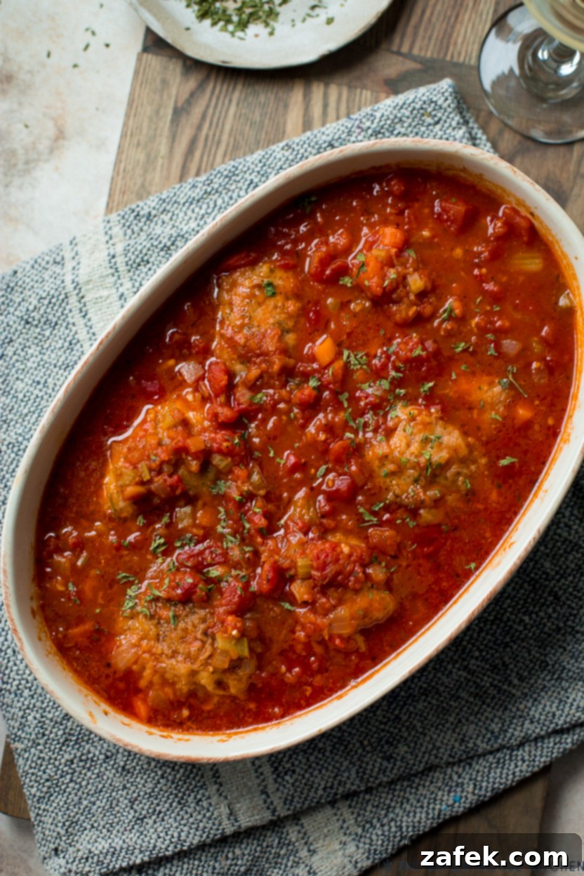 Rustic Braised Chicken with Root Vegetables 3 Up close overhead photo of a baking dish of chicken osso buco