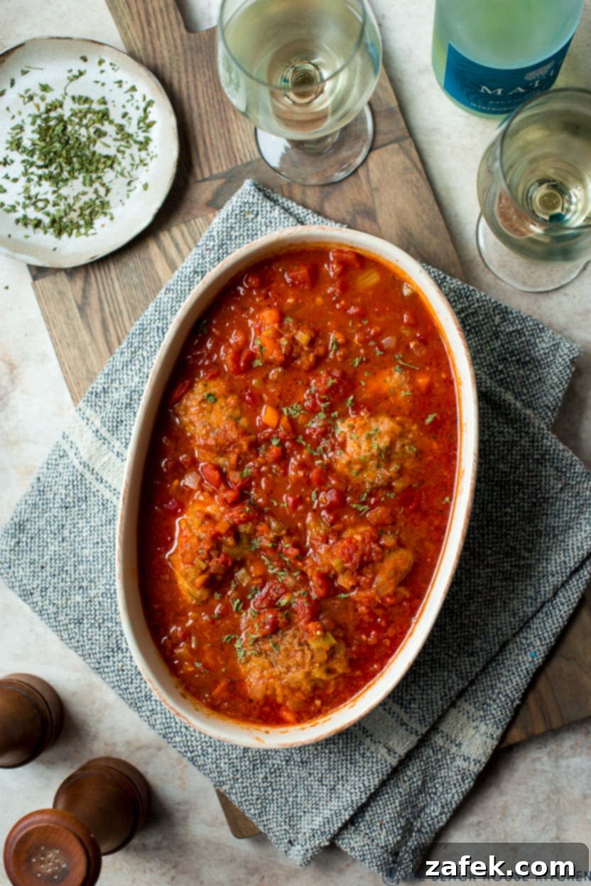 Rustic Braised Chicken with Root Vegetables 4 Overhead photo of a baking dish of chicken with a rich tomato sauce
