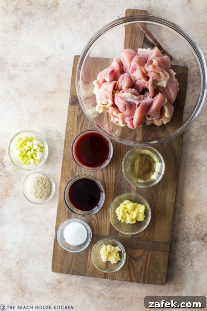 Crispy Gochujang Chicken Stir-Fry 4 Overhead photo of individual ingredients for a stir-fried chicken dish, including gochujang, soy sauce, sugar, chicken, garlic, and ginger.