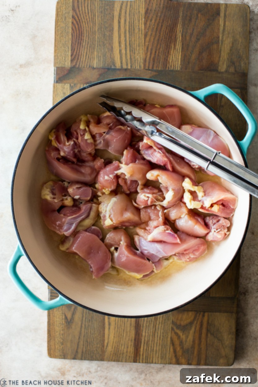 Crispy Gochujang Chicken Stir-Fry 6 Overhead photo of a skillet of pre-cooked chicken pieces browning beautifully, showing the golden-brown crust.